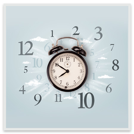 A clock with numbers surrounding it and clouds in the background