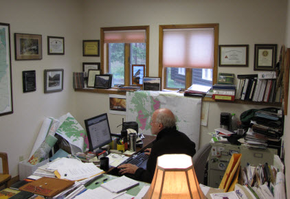 Photo of an Agency Administrator working on his computer in his office. 